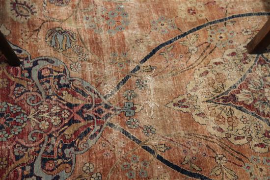 A Kerman carpet, the rose madder field with an all over medallion design, 15ft 10in. x 11ft 8in. (worn)